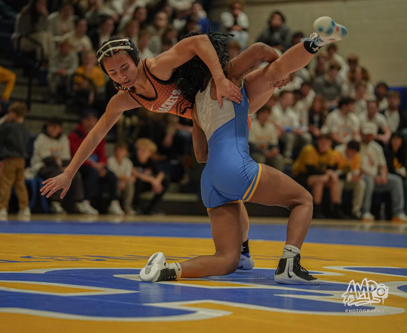 Tamara Humphries lifting an opponent across her shoulders during a college match.